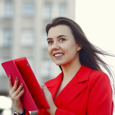 Woman in red jacket use a tablet Woman in red jacket use a tablet